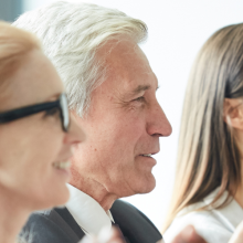 photo of board members smiling and applauding