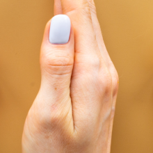 hand between to wooden people shaped blocks