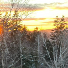 photo of Julie beside a beautiful Vermont sunset