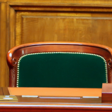 photo of three leaders' seats in a formal government hearing space