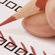 hand holding pencil and completing an assessment