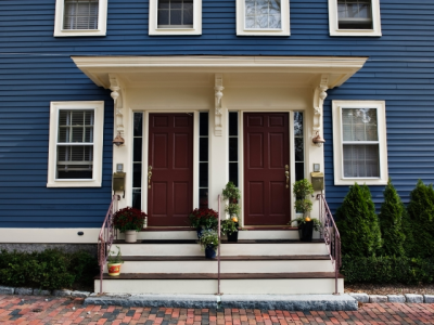 porch stairs climb to two front doors of duplex housing