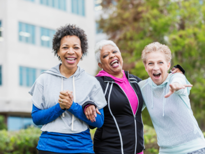 three older adults smiling and laughing