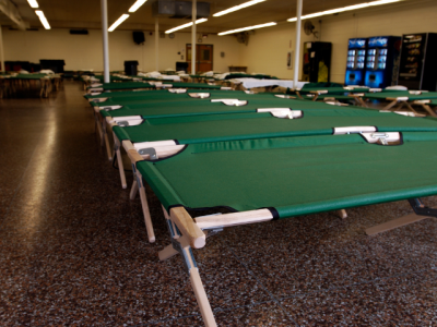 photo of freshly set up cots in a large room