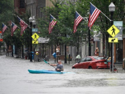 photo of kayaker in flooded downtown Barre, Vermont