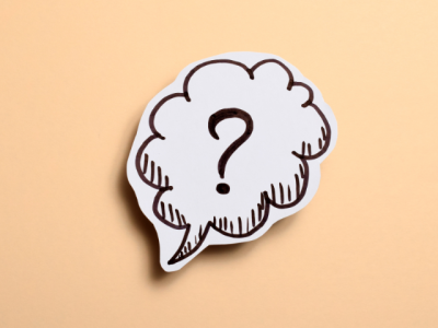 cartoon question bubble on tan background