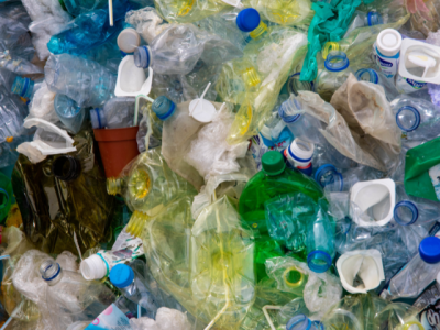 dense pile of empty crushed plastic bottle, yogurt containers, grocery bags, and more