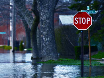 Photo of a flooded street with a stop sign