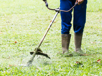 photo of a person from the waist down using a weed whacker