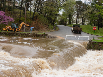 flood water cascading over a road