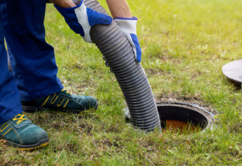 person pumping septic from a manhole access