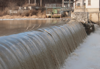 water flowing over a mid-size dam