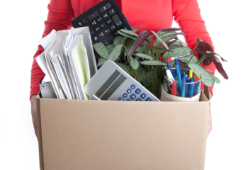woman holding box of stuff from office. unemployed. 