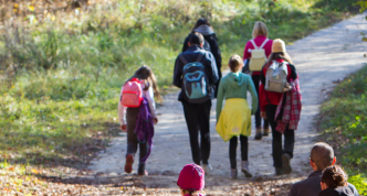 mixed age group hiking on gravel path