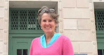 Photo of Kathleen in front of the Madison (Wisconsin) Municipal Building