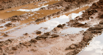 photo of very wet and rutted dirt road