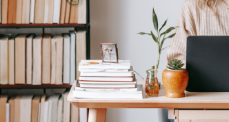 person at desk with books